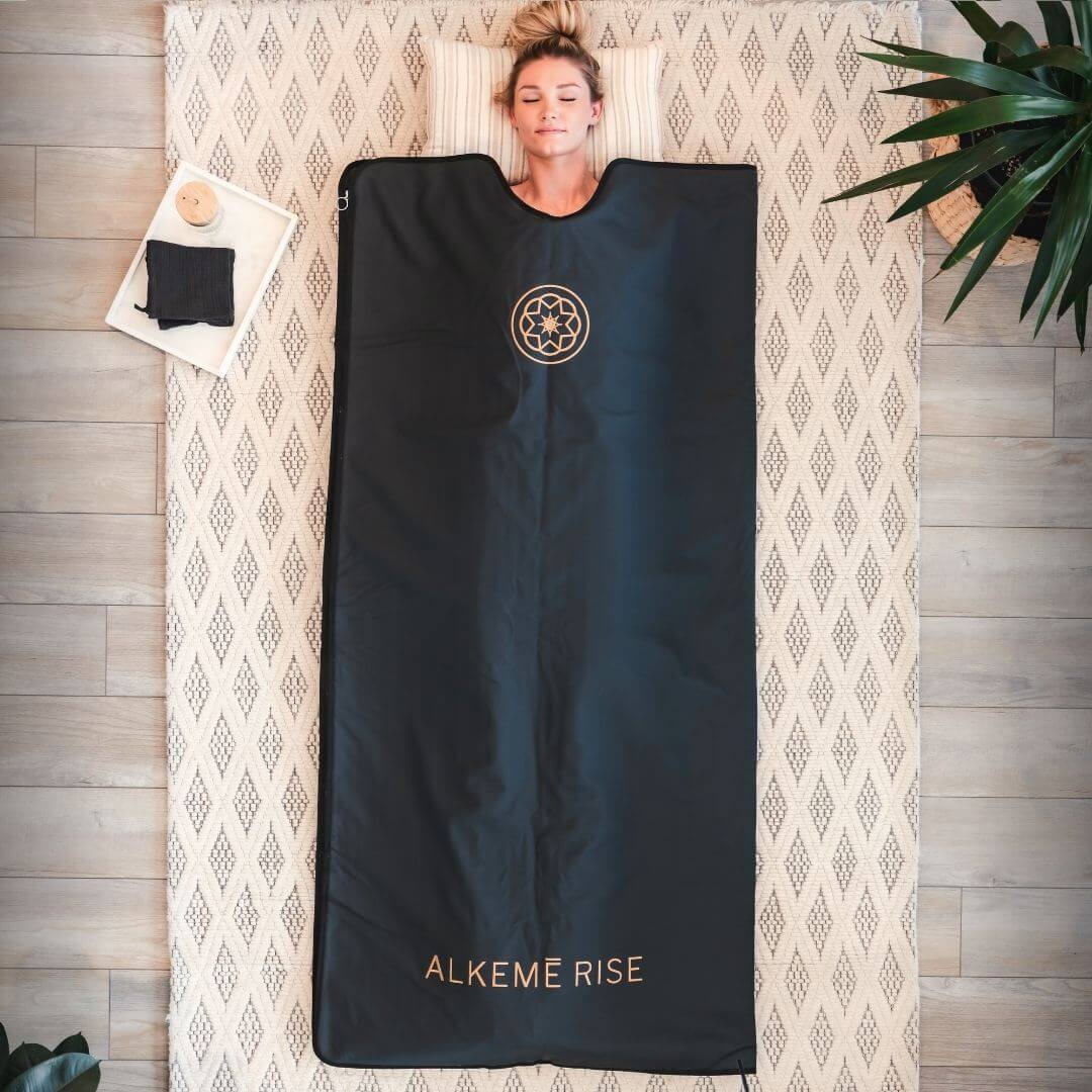 women laying in the black infrared sauna blanket