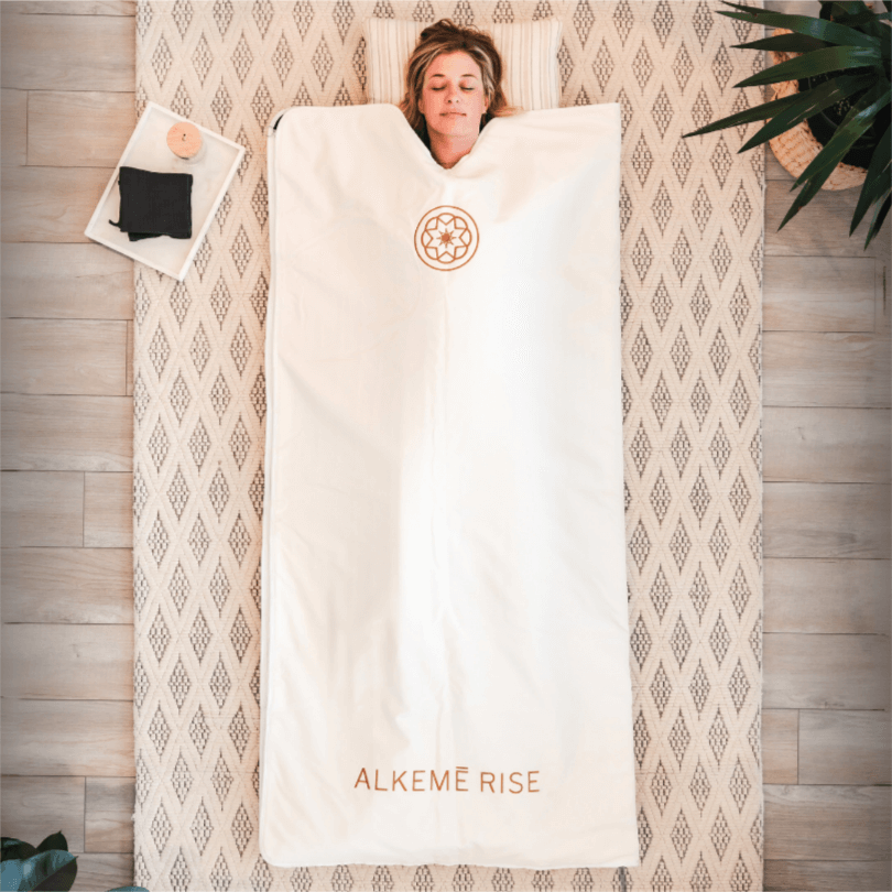women laying in the white infrared sauna blanket