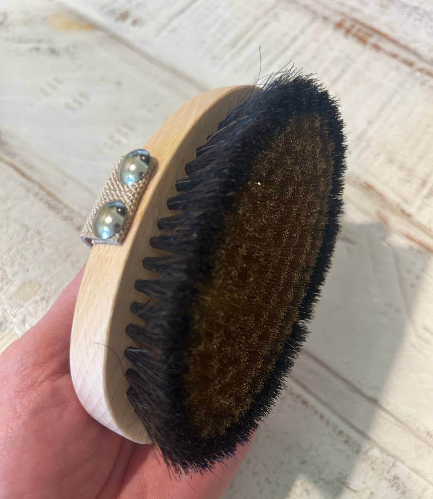 Close-up view of the Alkemē Rise Copper Dry Brush, showcasing its natural bristles and copper core for elevated dry brushing rituals.