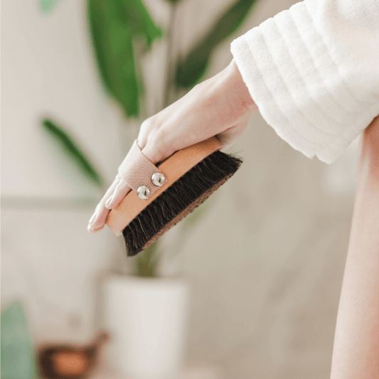 Ion-charged copper dry brush with natural bristles used on dry skin for exfoliation and lymphatic support